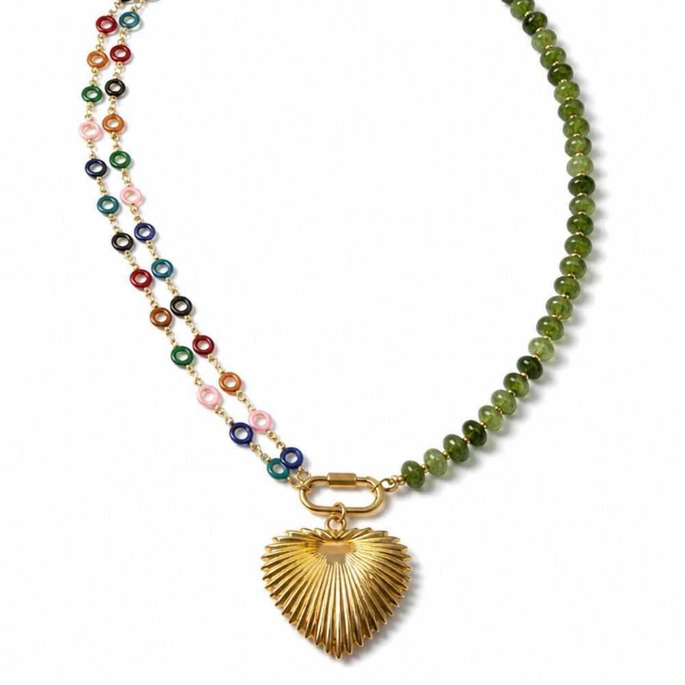 A beaded necklace featuring a strand of polished green beads and a dangling gold heart-shaped pendant, with a secondary strand of small multicolored round beads on a white background.